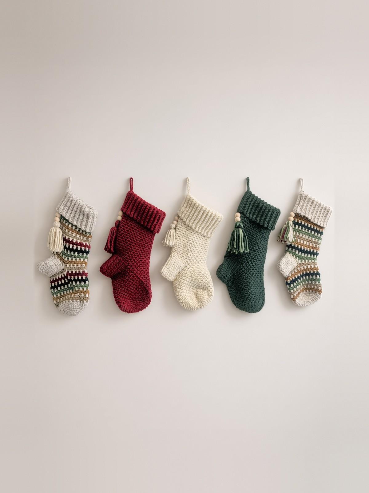 Row of handmade crochet Christmas stockings in holiday colors