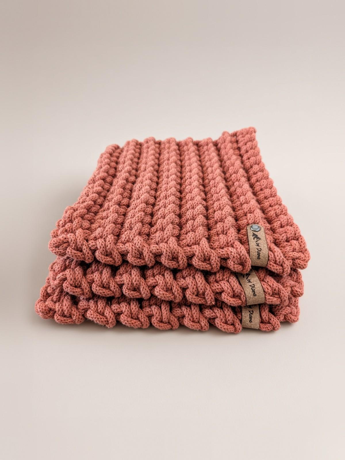 Side view of stacked terracotta crochet hot pads